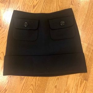 Women’s Burberry Black Mini Skirt with front pocket detail and bottom cuff hem.